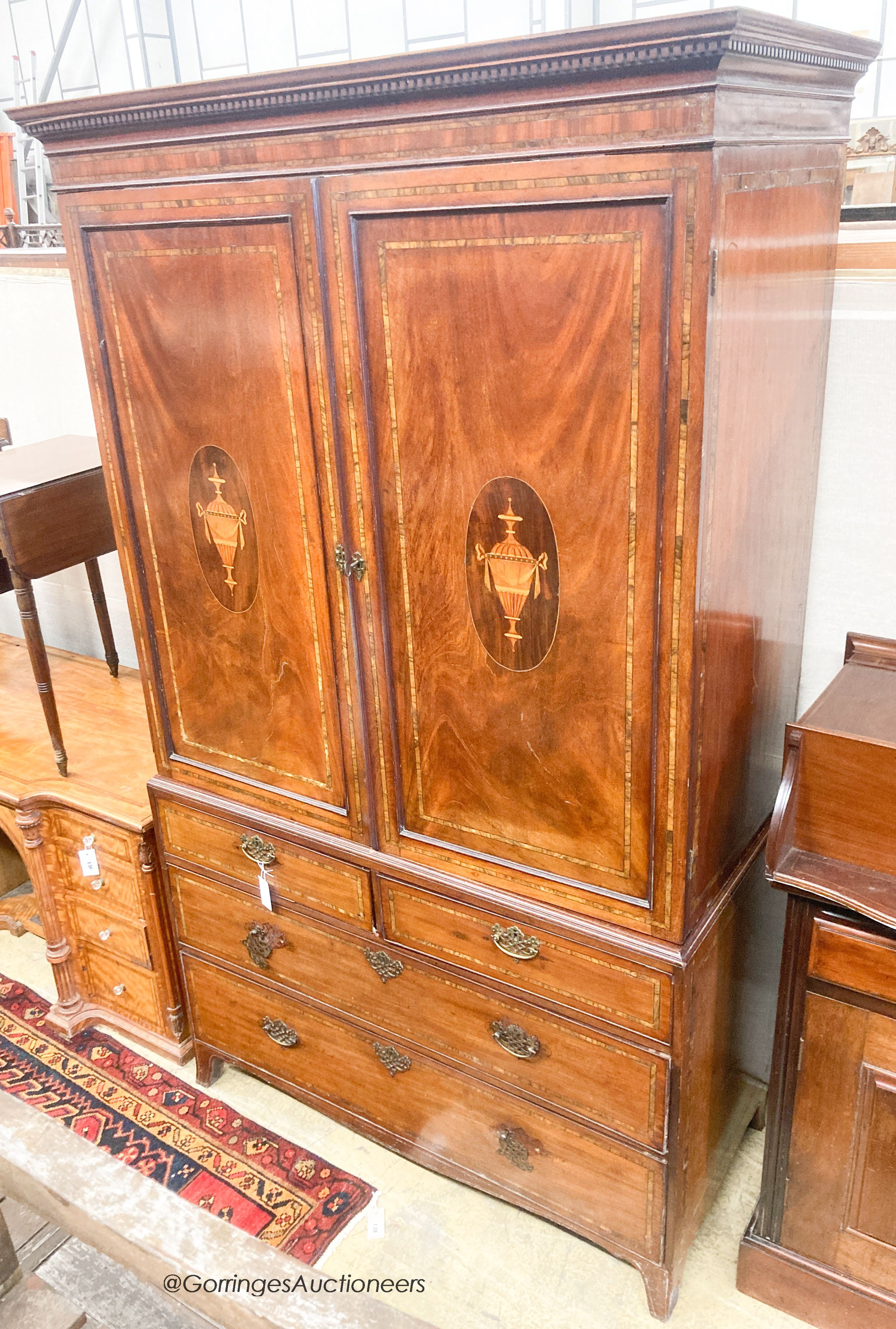 A George III inlaid mahogany linen press (lacks slides), width 126cm, depth 58cm, height 212cm